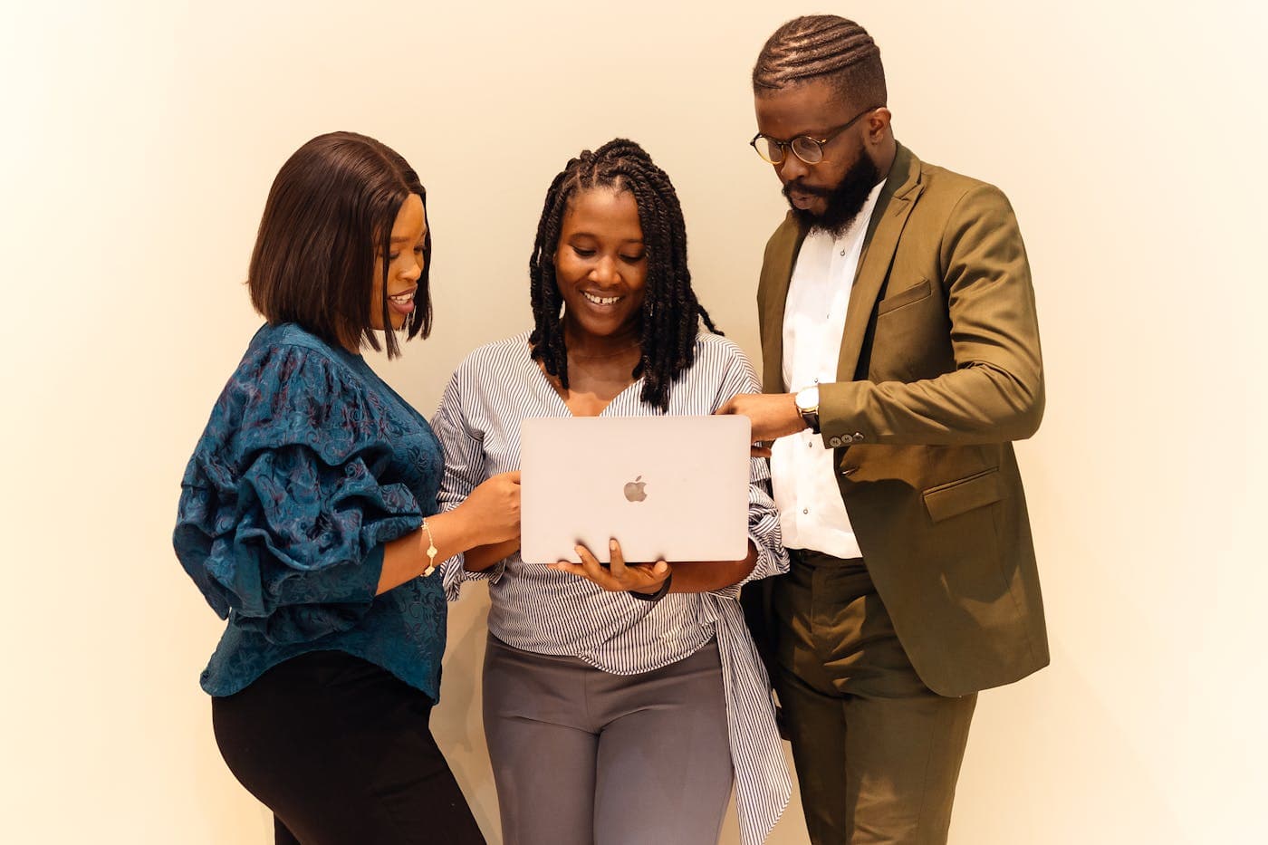 Team members reviewing work together on a laptop