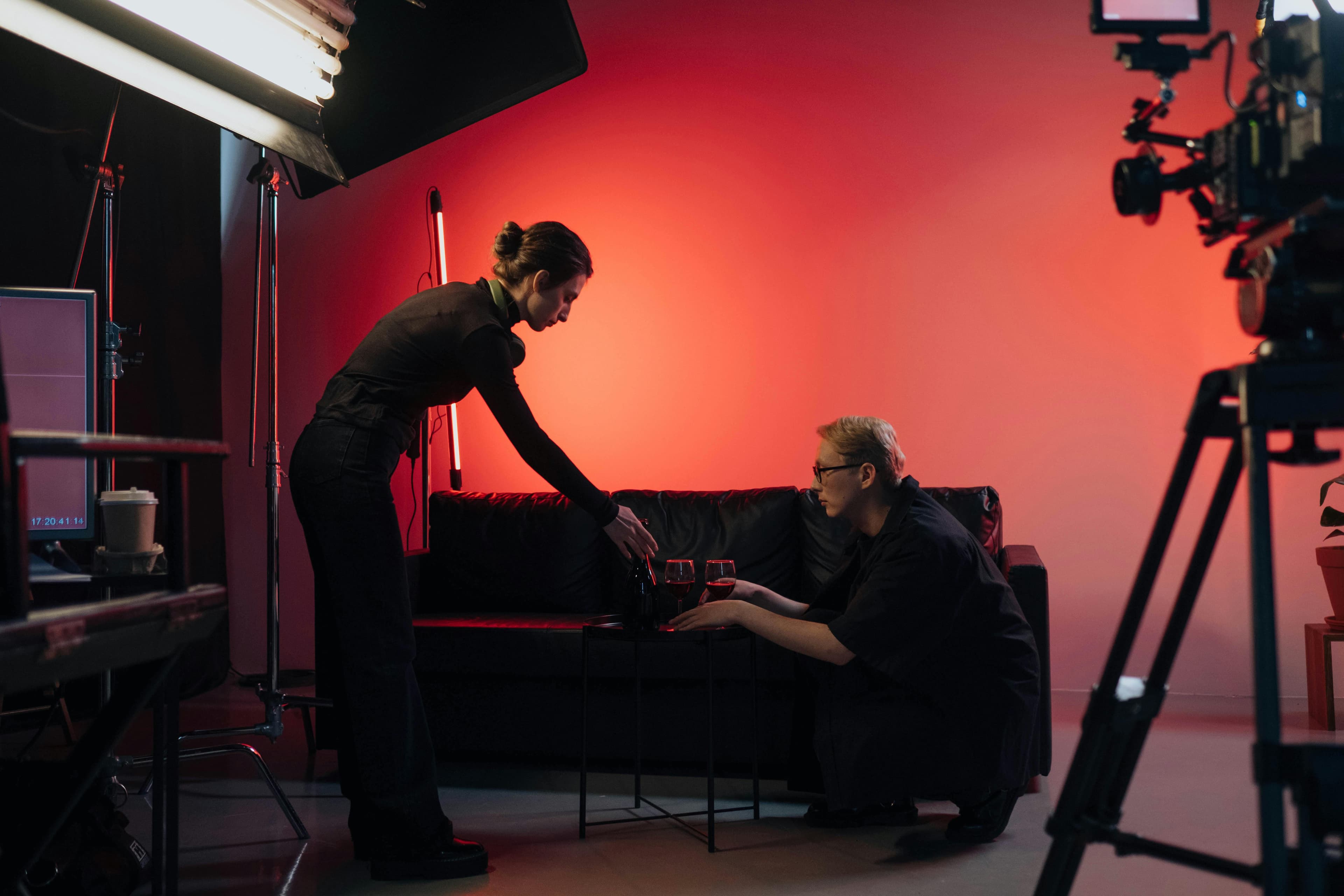 Production crew adjusting a set during a filmed studio shoot