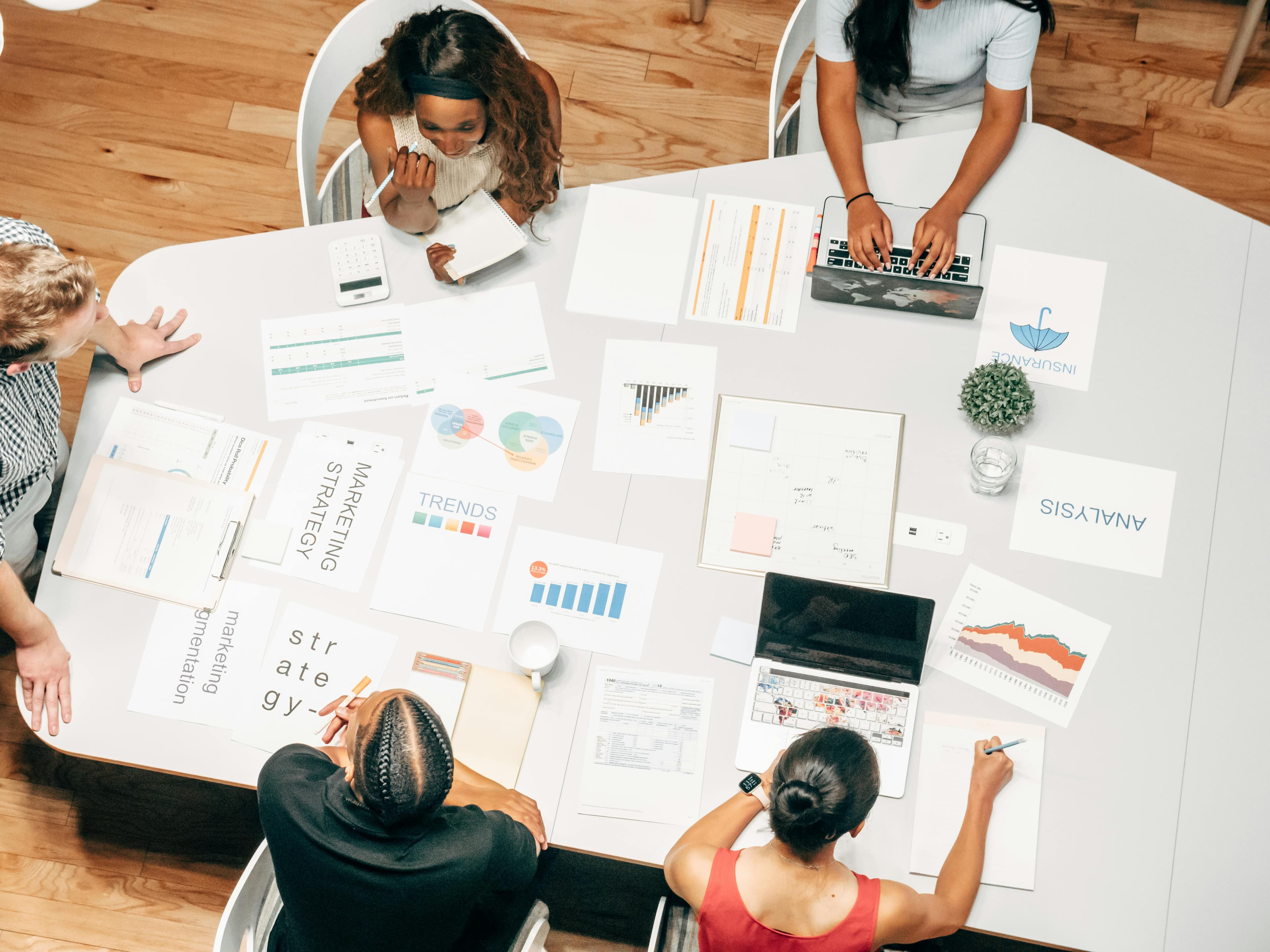 Overhead view of a diverse team planning media and advertising strategy